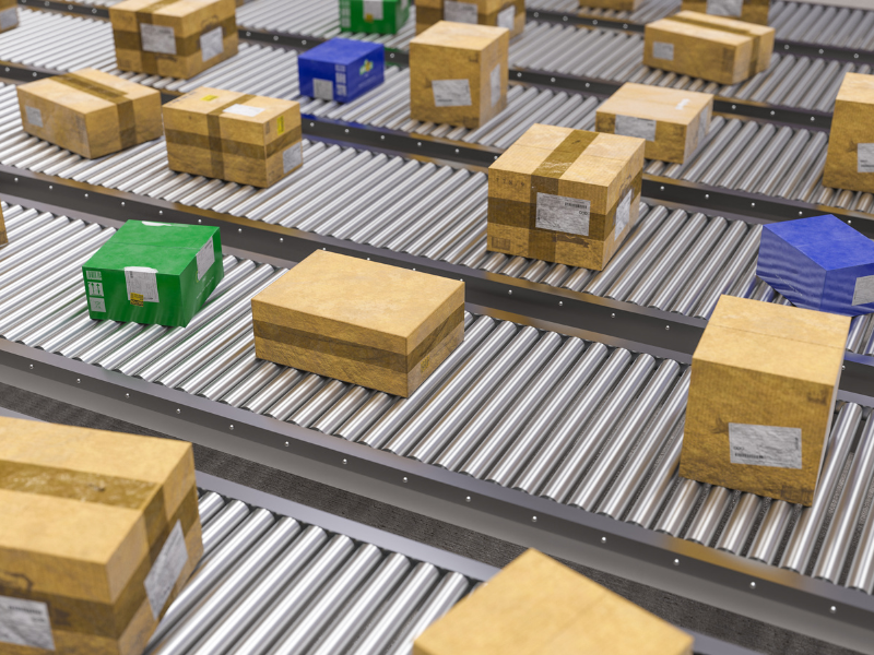 Boxes moving along a conveyor belt inside a logistics facility