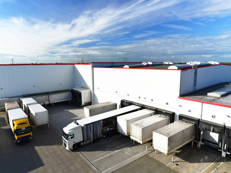 Trucks loading and unloading at a large professional warehousing facility