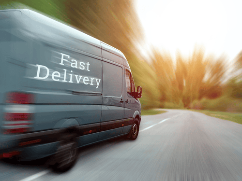 A fast-moving delivery van speeds down the road, ensuring timely service for any SME