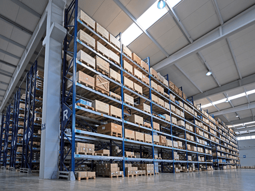 Tall warehouse shelving units efficiently store goods using a fully managed inventory tracking system