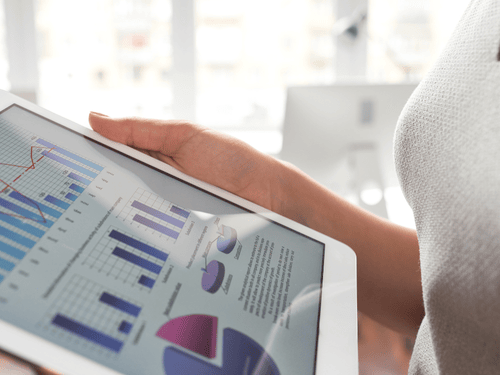 Business analyst checks managed inventory performance metrics and logistics reports on a digital tablet